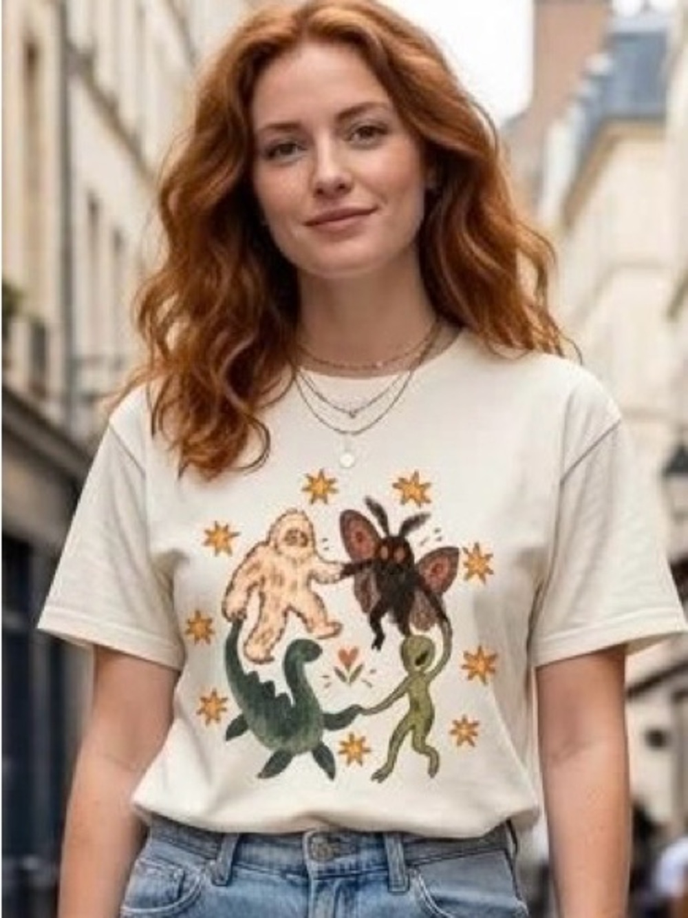 Dancing Cryptids Graphic Tee Bigfoot Mothman Nessie Alien Folk Art Cream T-Shirt